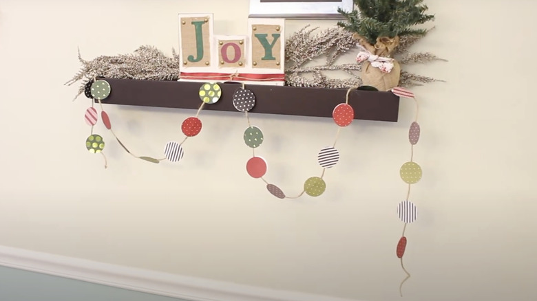 A Christmas garland made from round paper coasters.