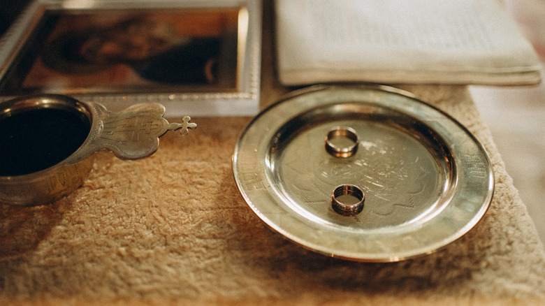 A rimmed silver plated coaster is repurposed as a ring dish.