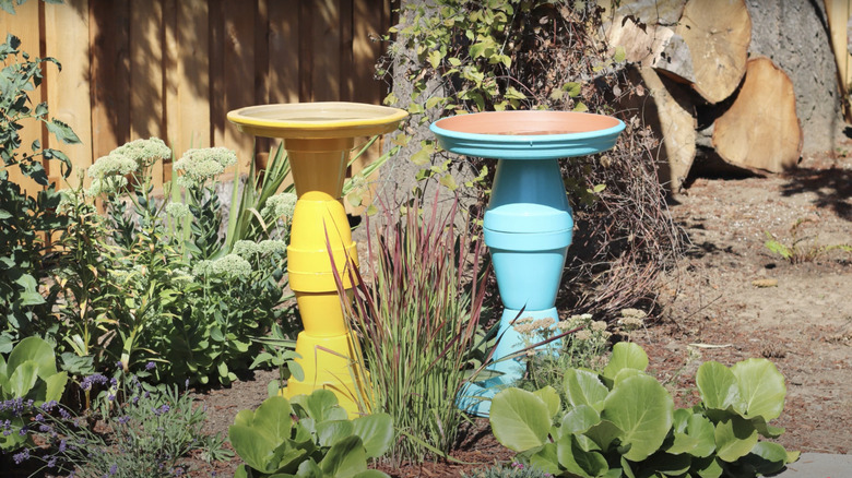 Bird baths made from painted and stacked plastic planters and saucers