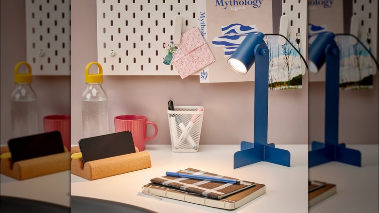 blue metal desk lamp on desk