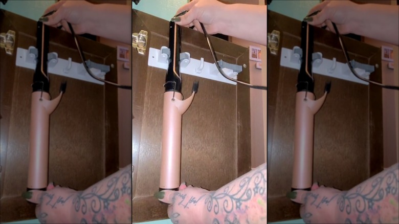 person hanging curling iron