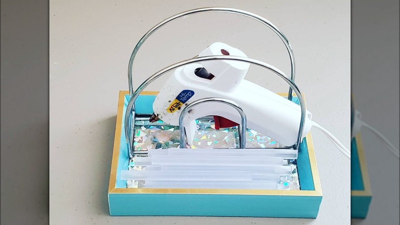 hot glue gun on blue tray