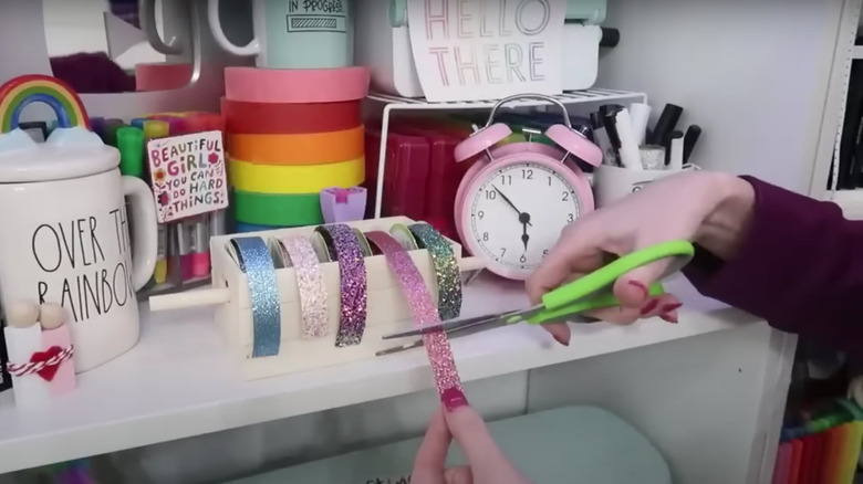 person cutting ribbon from dispenser