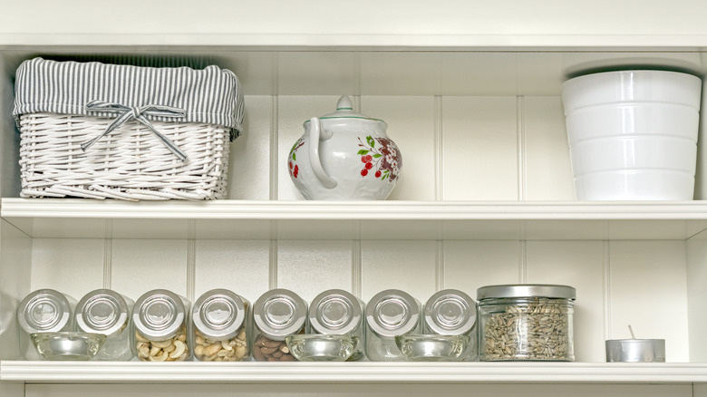 basket on white shelves in kitchen