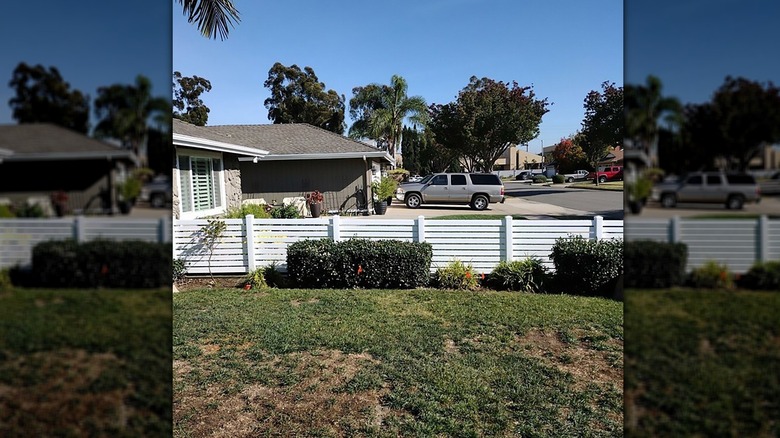 White horizontal fence around front yard