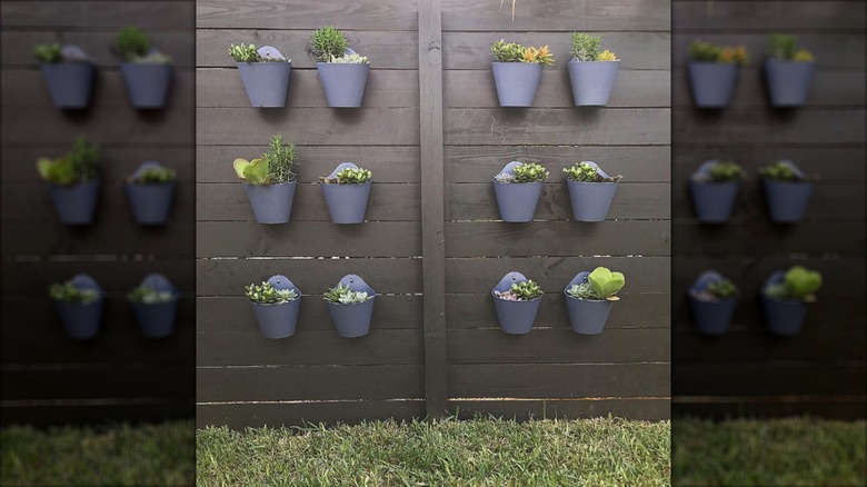 Black fence with grey planters