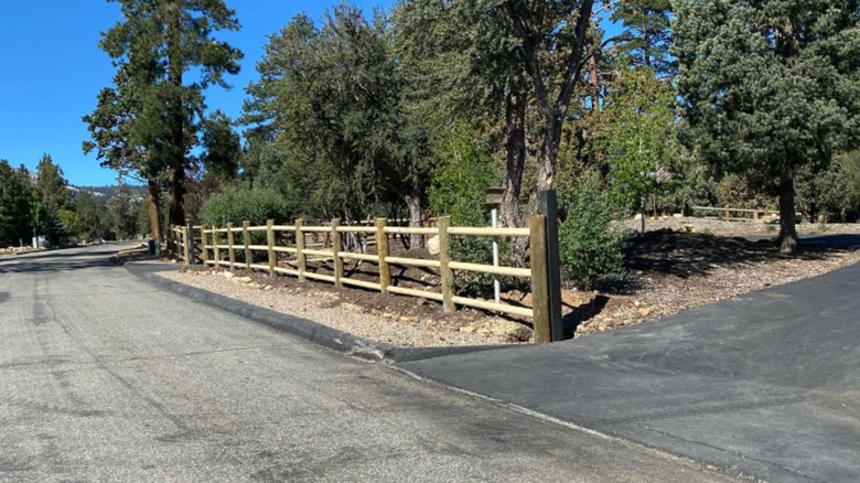 Fence made from logs along road