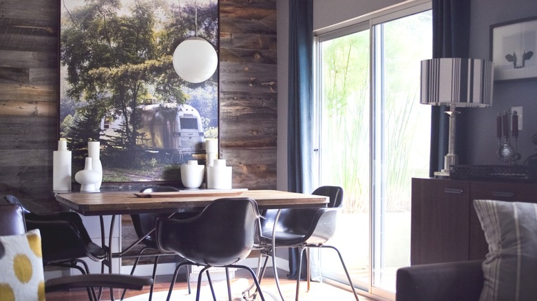 man installing reclaimed wood wall