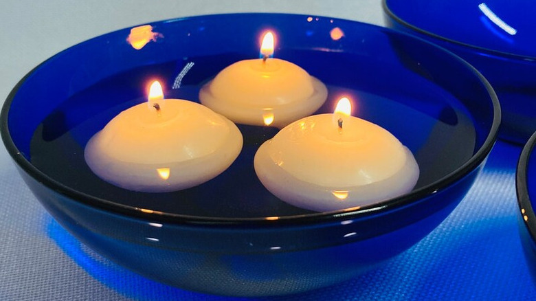floating candles in blue bowl