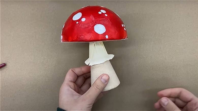 hand holding red mushroom decoration