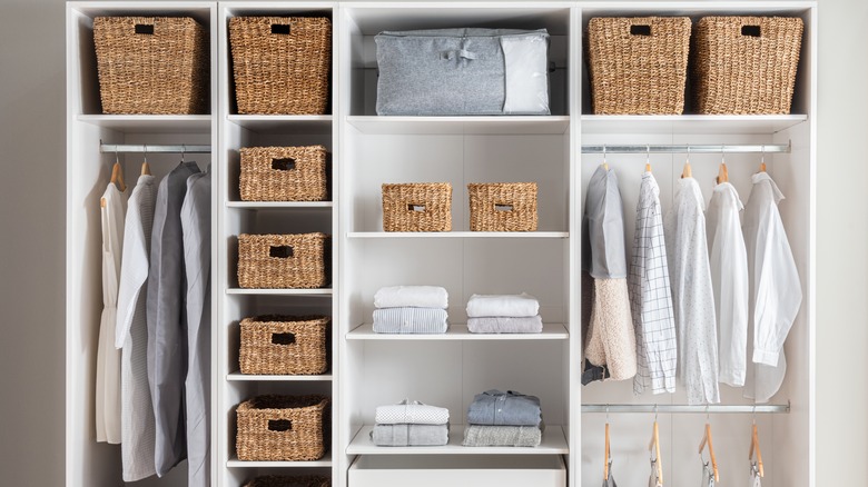 Lots of wicker baskets in an organized closet