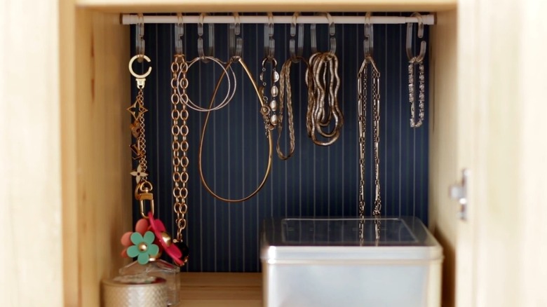 Jewelry hanging from a small tension rod