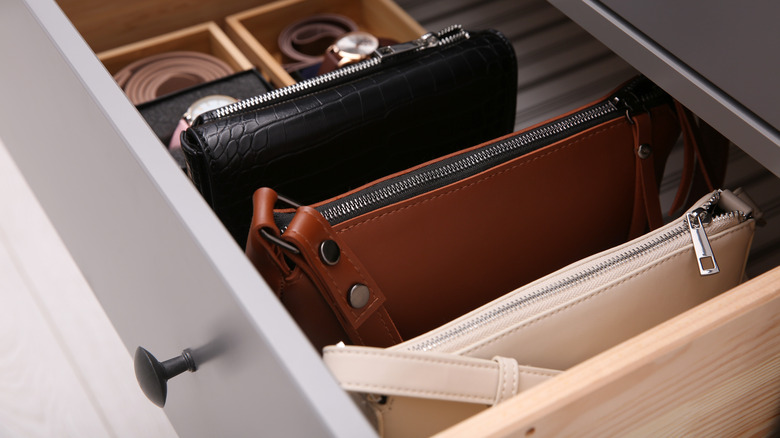 Bags and belts in a closet drawer