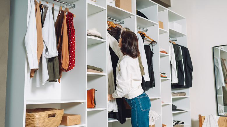 Woman putting in clothes in a wardrobe