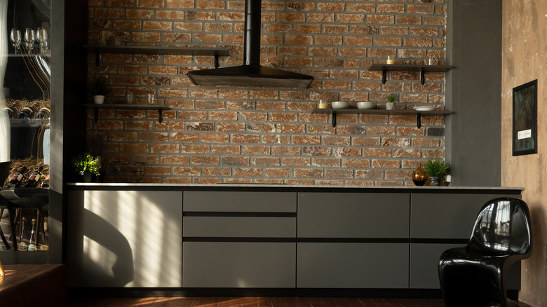 Dark kitchen brick backsplash