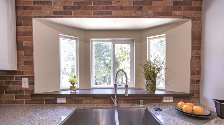 Brick surrounding kitchen window backsplash