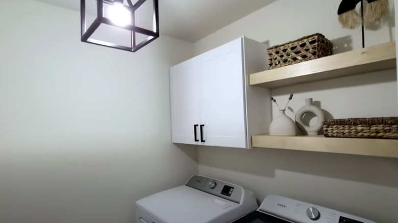 Renovated laundry room with shelves and cabinets