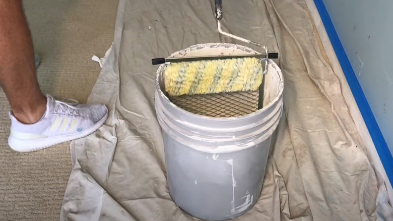 paint grid and roller in bucket