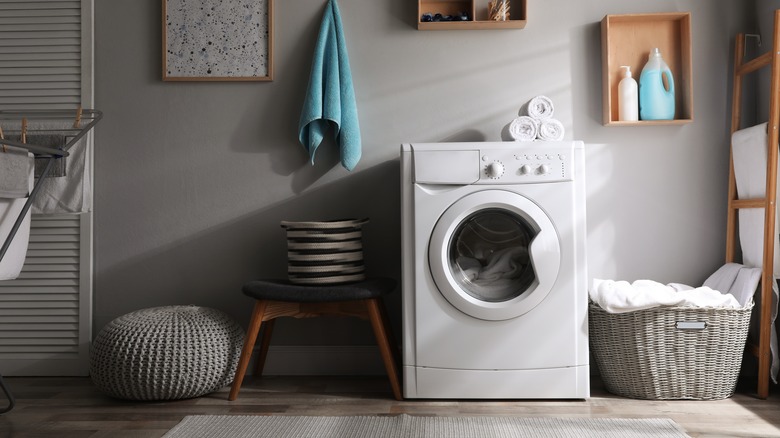 gray laundry basket near washer