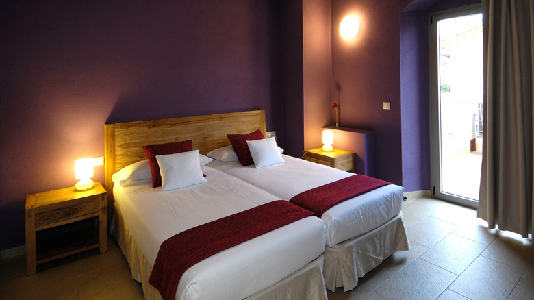 purple room with two beds