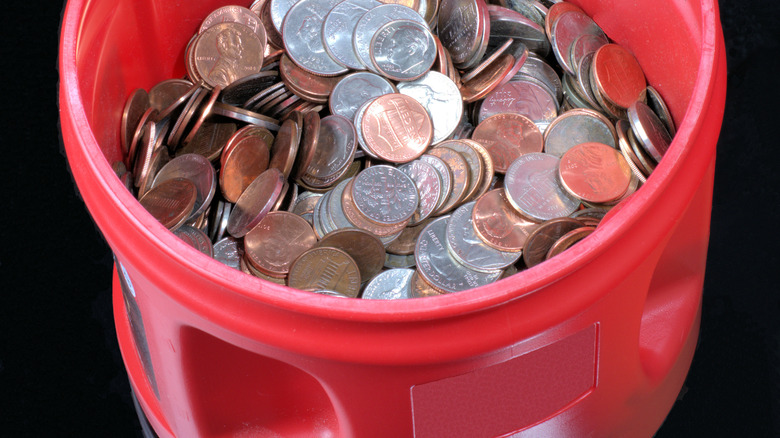 Coins in plastic coffee can