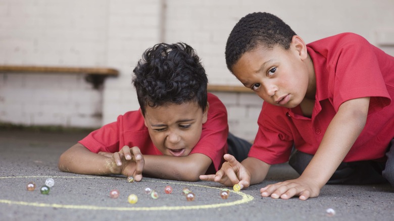 Kids playing with marbles