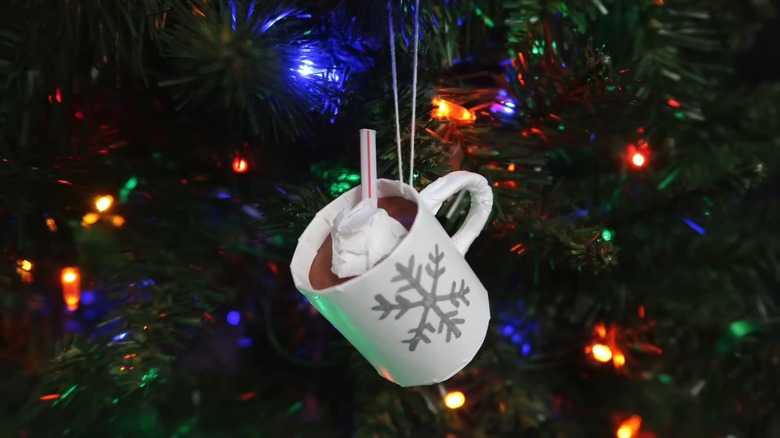 Hot chocolate mug ornament hanging from Christmas tree