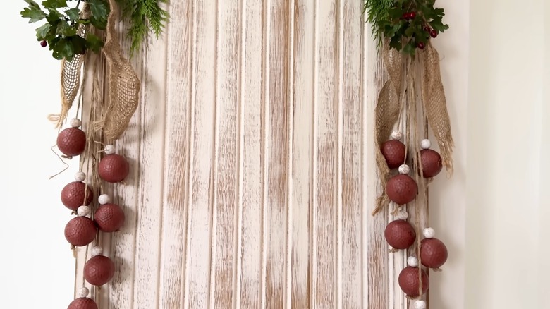 Golf ball hanging decor with burlap and evergreen boughs