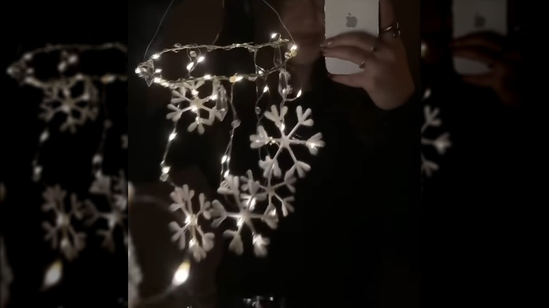 Person holding a glowing snowflake DIY