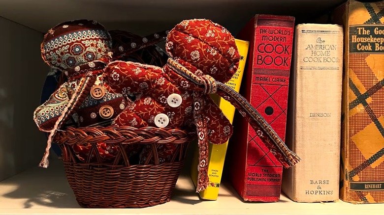 Gingerbread pillow in basket near books