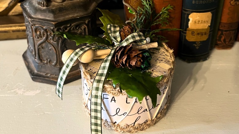 Christmas drum decorated with ribbon, pine cones, and evergreen