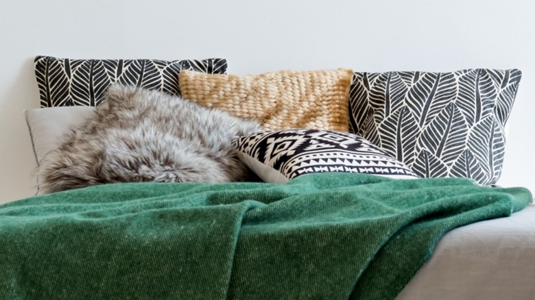 Pillows with different designs on a bed