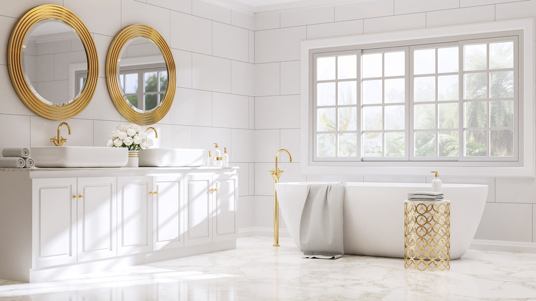 golden mirrors in white bathroom