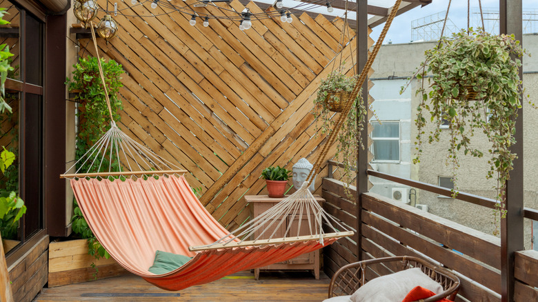 orange hammock hanging on balcony