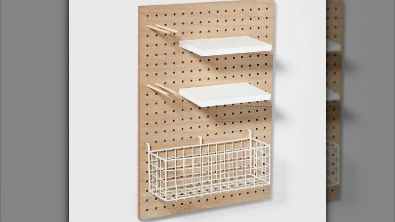 wooden pegboard with white shelves