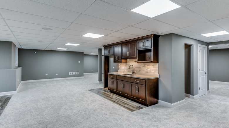 gray basement with kitchenette