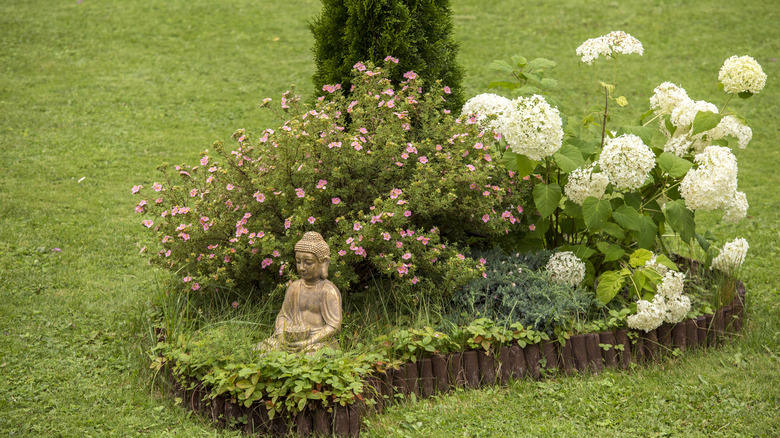 Flower bed with statue