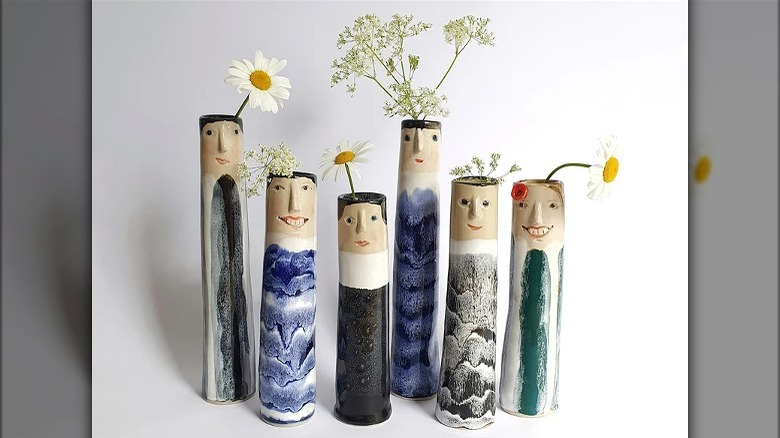 Six bud vases with faces