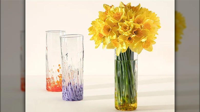 Three glass vases with daffodils