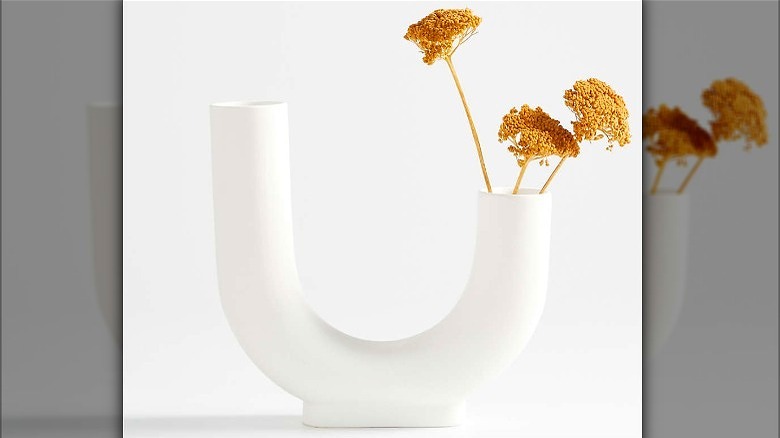 U-shaped white vase with flowers