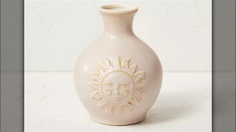 Stone vase with sun face