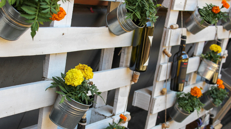pallet fence planters with flower buckets