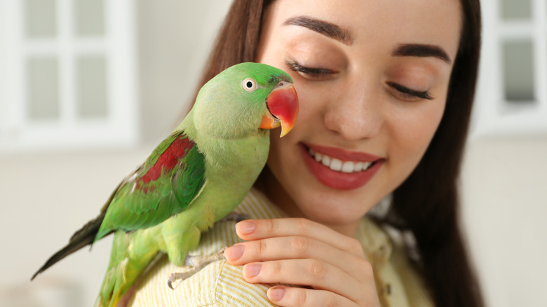 bird on woman's shoulder