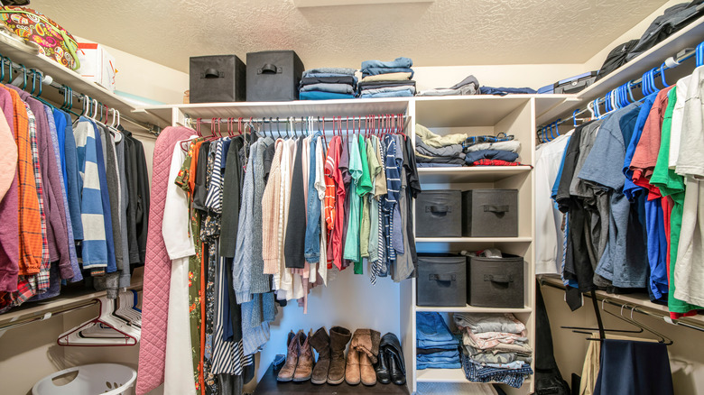 full bedroom closet with clothes