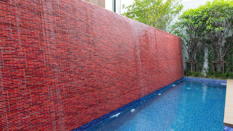 backyard fountain with red wall