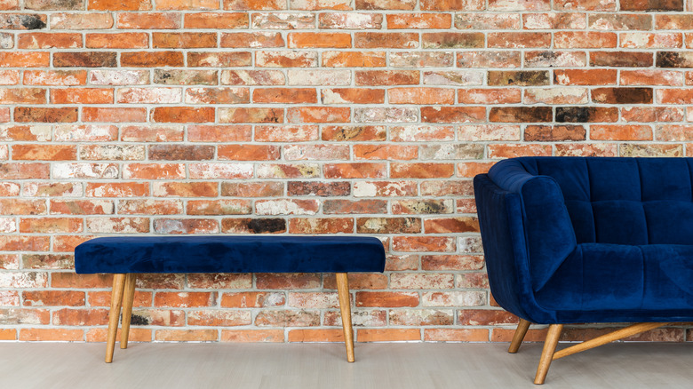 blue sofa and brick wall