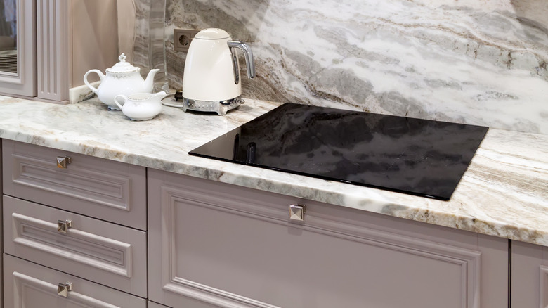 Lilac cabinets and marble countertops