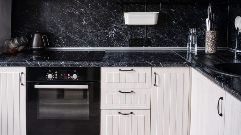 Black marble countertops white cabinets