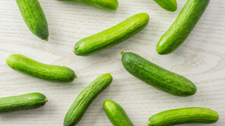 Miniature cucumbers on wooden table