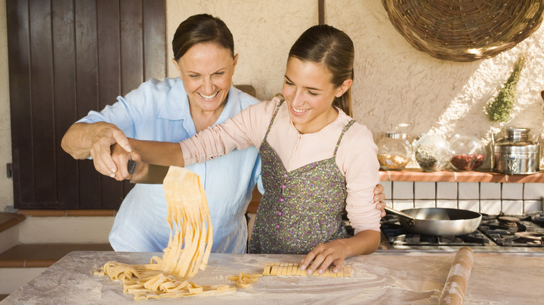 Two people making pasta